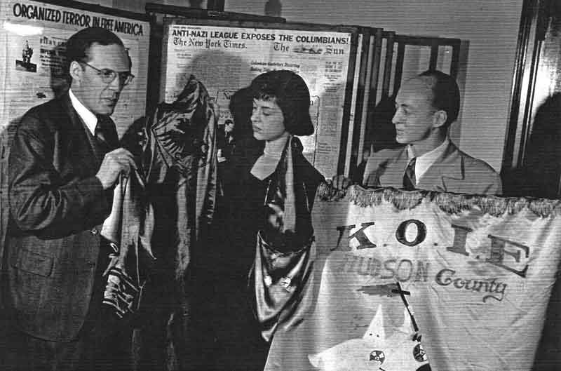 Stetson Kennedy (right) sharing some of the Klan regalia collected during his infiltration of the group