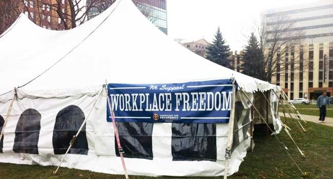 Tea Party-aligned group Americans For Prosperity camped outside Michigan legislature to get anti-union law passed.